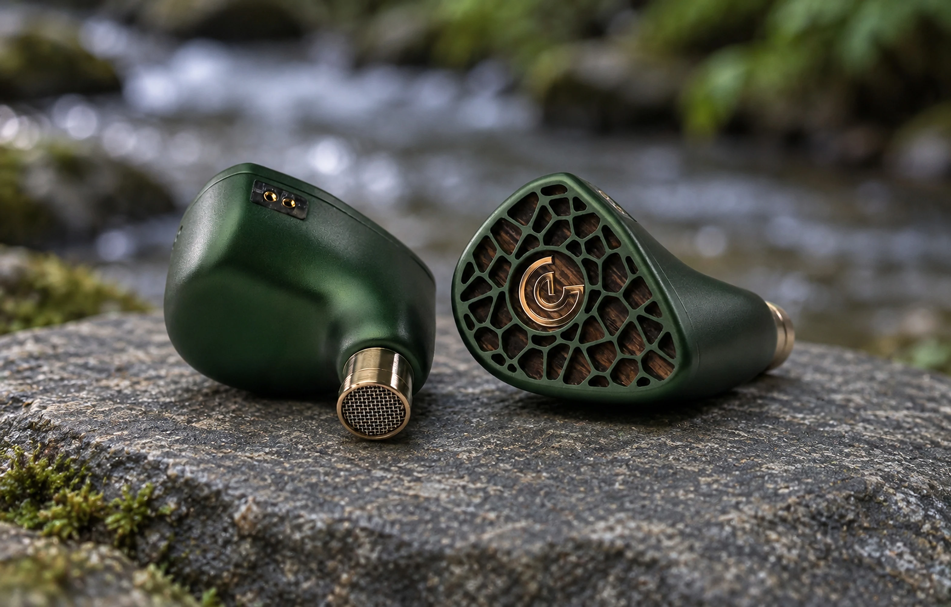 A pair of Leszy in-ear monitors on a stone by a forest stream